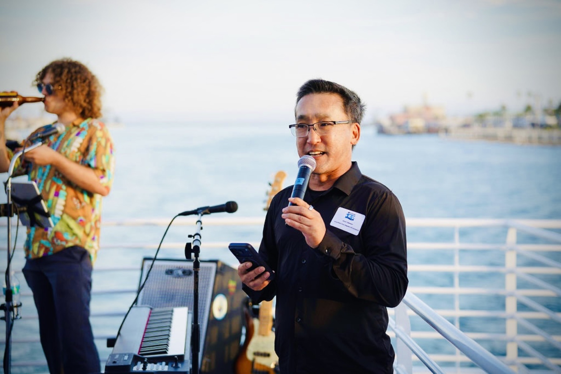 Stuart Takehara speaks aboard Harbor Breeze on the Long Beach waterfront
