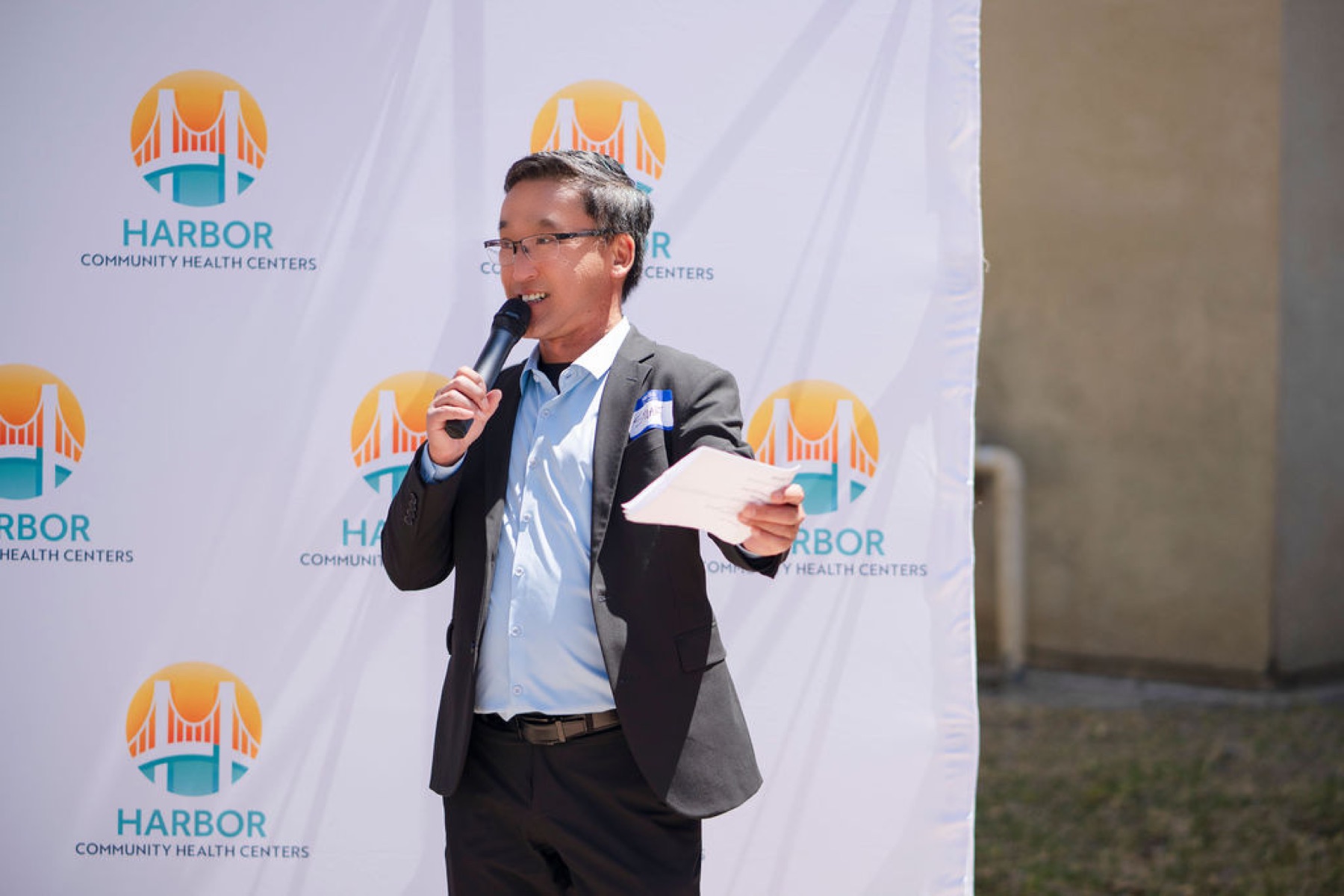 Stuart Takehara addresses guests at the Harbor Community Health Centers grand opening