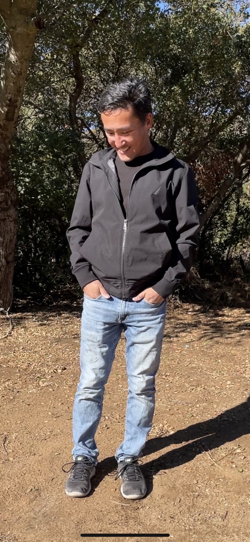 Stuart Takehara outdoors in a wooded setting