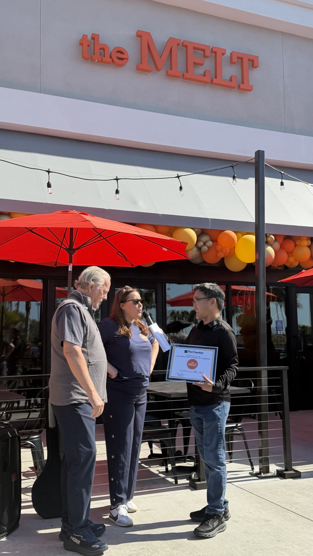 Stuart Takehara presents a Chamber certificate during The Melt’s Long Beach grand opening