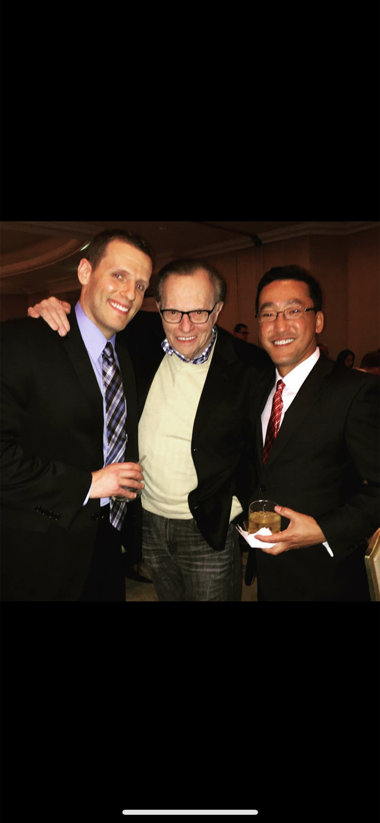 Stuart Takehara and a colleague with broadcaster Larry King at an event